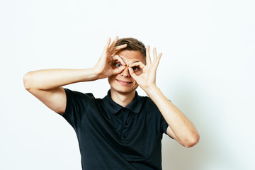 man looking through hands, making binoculars