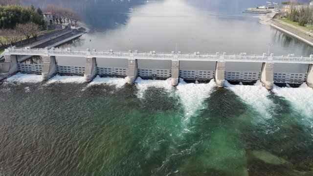 Dam with flowing water at hydroelectric power station located south of Lake Como.