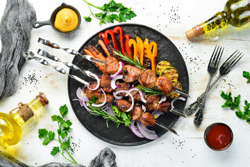 Grilled veal skewers and grilled vegetables. Top view. Barbecue. - obrazy, fototapety, plakaty
