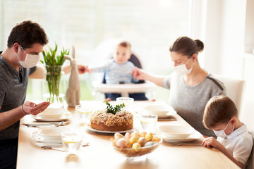 Family at home quarantine over Easter table