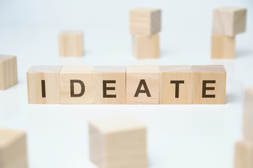 Modern business buzzword - ideate. Word on wooden blocks on a white background.