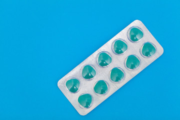 Pills for sexual male health on a blue background