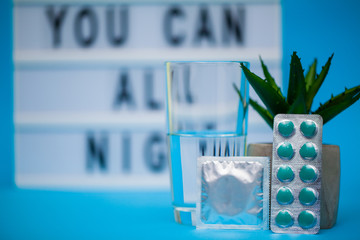 Pills for sexual male health on a blue background