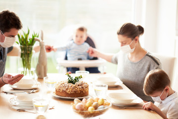 Obraz na płótnie Canvas Family at home quarantine over Easter table