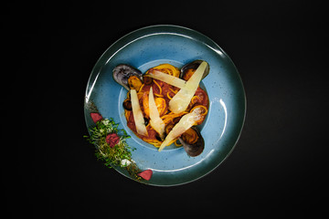 tasty food on a black background, dark background dishes of different countries, plates salads meat