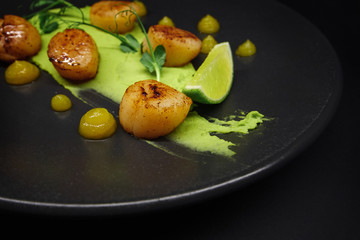 tasty food on a black background, dark background dishes of different countries, plates salads meat