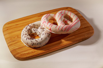 Pretzel cakes are on a wooden Board on the table.