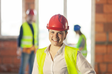 worker, investor, inspector or architect with her team. construction site engineers on site. satisfied expression