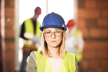 worker, investor, inspector or architect with her team. construction site engineers on site. satisfied expression