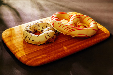Pretzel cakes are on a wooden Board on the table.