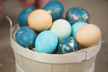 Basket with Easter eggs, festive colored eggs.