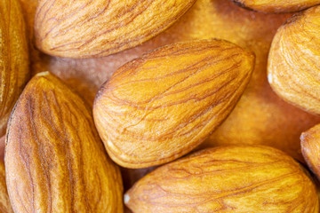 Peeled almonds close-up. Brown background. Macro photo of nuts. The concept of healthy food, vegetarianism..