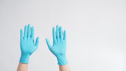 Hands with blue gloves on white background.