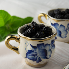 ripe mulberry in cups