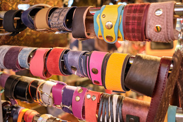 A counter with different handmade leather bracelets.