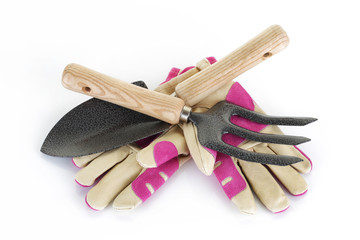 Garden fork trowel and gloves on white