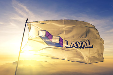 Laval of Quebec of Canada flag waving on the top sunrise mist fog