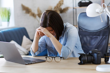 Tired freelancer working overtime in home office.Stressed businesswoman have financial problems and searching ideas to overcome financial crisis.Entrepreneur in bankruptcy.Burnout and overwork concept