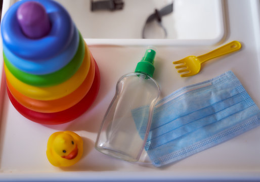 icture for banner liquid antiseptic medical mask and children colorful toys on a children's table for food COVID 19 hand washing disinfection