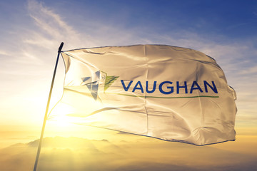 Vaughan of Ontario of Canada flag waving on the top sunrise mist fog
