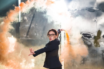 Obraz premium Pasadoble, latin solo dance and contemporary dance - Young beautiful female dancing into smoke cloud