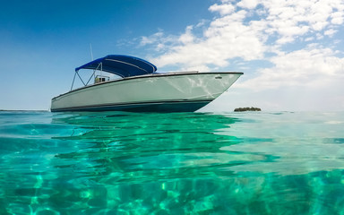 A boat sits on turquoise Caribbean waters.