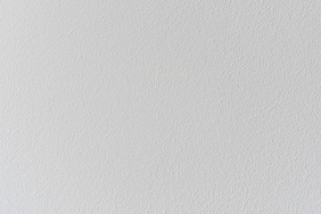 Textured concrete wall of the house. Decorative plaster. Abstract white background