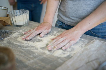 Obraz na płótnie Canvas a woman's hands pours and mix wheat flour. baker's hand closeup. Cooking cake