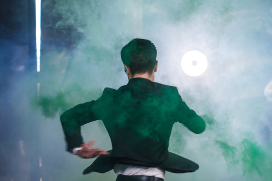 Pasadoble, latin solo dance and contemporary dance - Handsome male dancing into smoke cloud.