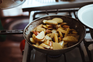Fried potatoes. Chips in a pan. A delicious dish of home cooking.