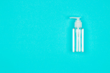 Hand alcohol sanitizer gel on blue background. Coronavirus protection. Top view. Flat lay.