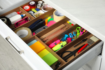 Different stationery in open desk drawer indoors