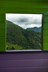 Wooden window, mountains and tropical rainforest