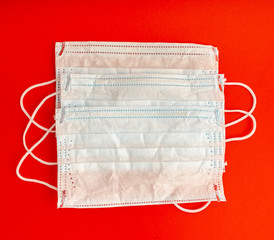 Set of three White medical masks. Medical protective masks over red background. Healthcare and...
