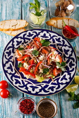 Fresh salad with beef, herbs and red pepper.