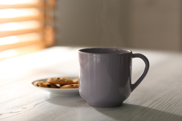 Tasty coffee and cookies on white wooden table. Good morning