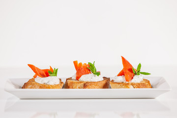 Plate of decorative fish bruschetta appetizer	
