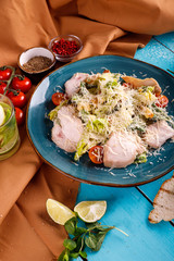 Caesar salad in a plate on the table