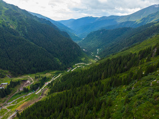 Fototapeta na wymiar Romania. Fagaras mountain range. Mountain highway Transfagarash. One of the most beautiful roads in the world. Popular tourist route. Drone. Aerial view