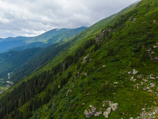Obraz premium Romania. Fagaras mountain range. Mountain highway Transfagarash. One of the most beautiful roads in the world. Popular tourist route. Drone. Aerial view