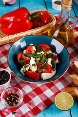 Freshly prepared Caprese salad with mozzarella, cherry tomatoes, Basil and arugula pesto.