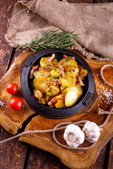 Fried potatoes with meat on a baking sheet