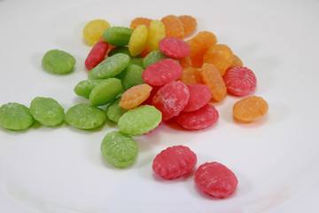 candies in different colors on a white background