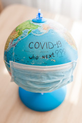 The inscriptions on the globe that are directed against the coronavirus