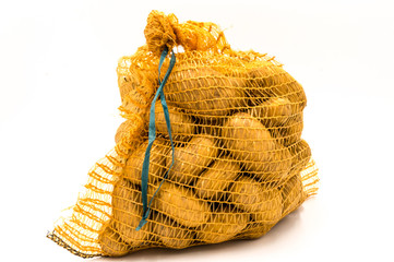 Ripe potatoes in burlap sack isolated