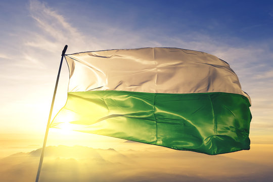 Fusagasuga of Colombia flag waving on the top sunrise mist fog