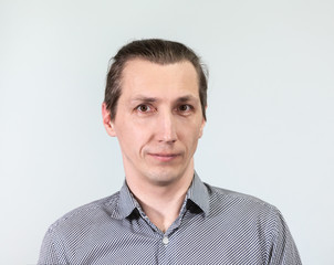 Obraz premium Portrait of an European man, looking at camera, grey background