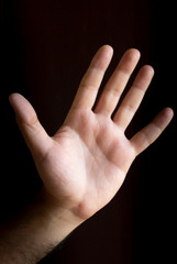 Man hand on black background. Gesture language with the hands. Non-verbal communication concept.