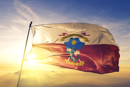Soacha of Colombia flag waving on the top sunrise mist fog