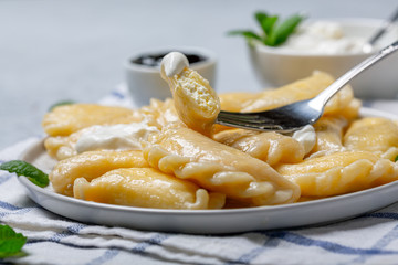 Traditional dumplings with cottage cheese and sour cream.